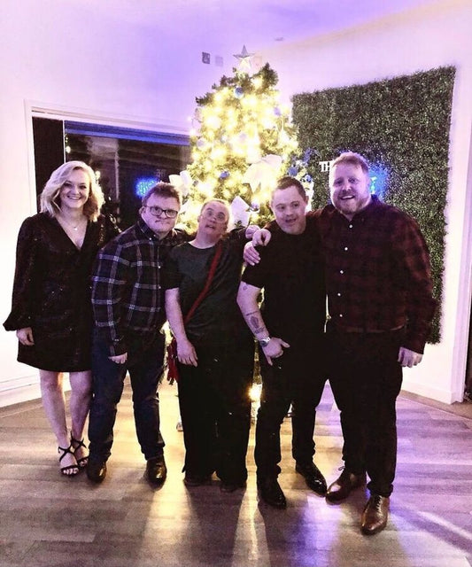 Staff from Stand Out Socks Stood in front of a Christmas Tree