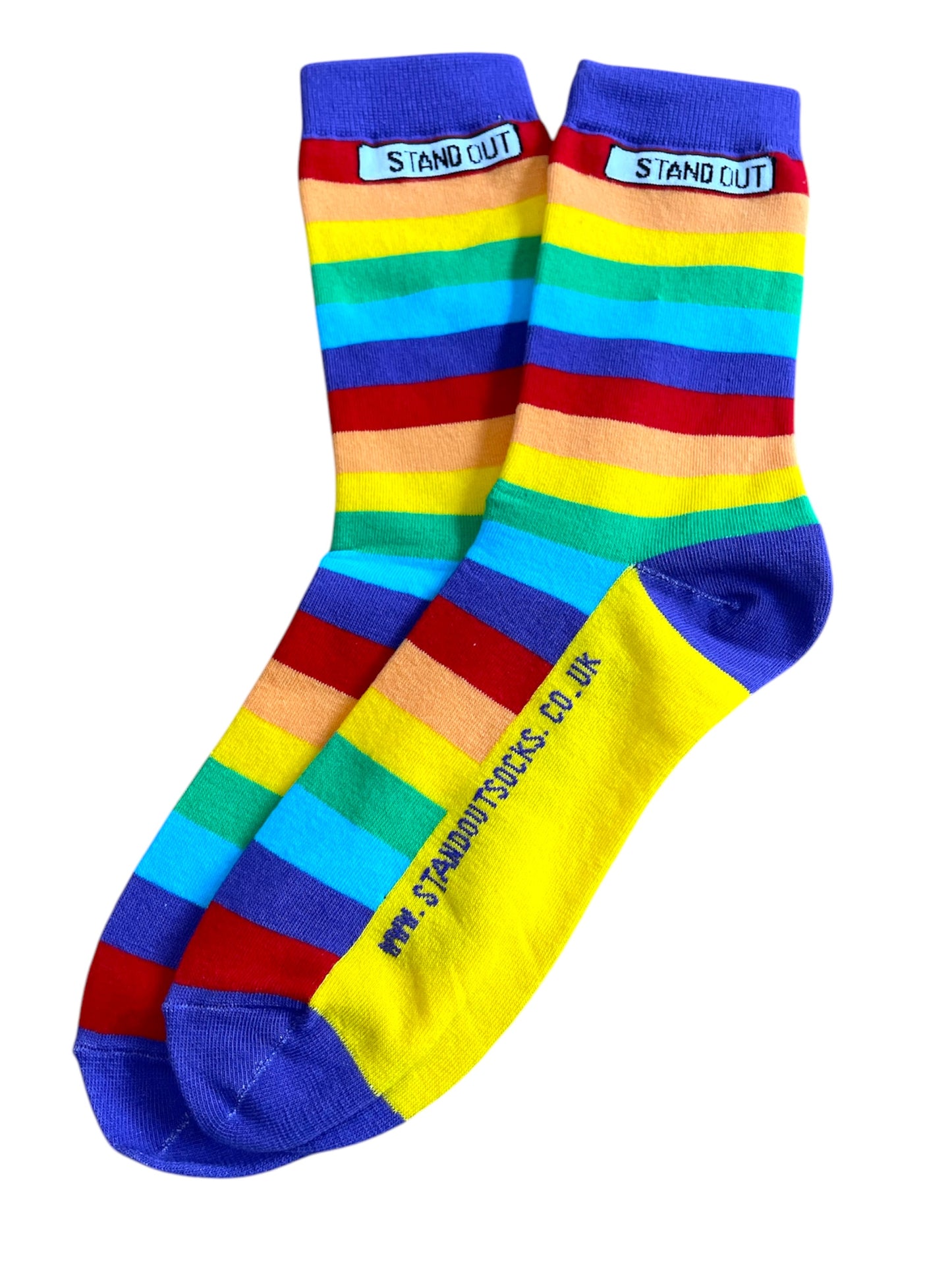 A photograph of a pair of Stand Out Socks Rainbow Pride design, showcasing vibrant rainbow stripes and the Stand Out logo near the cuff.