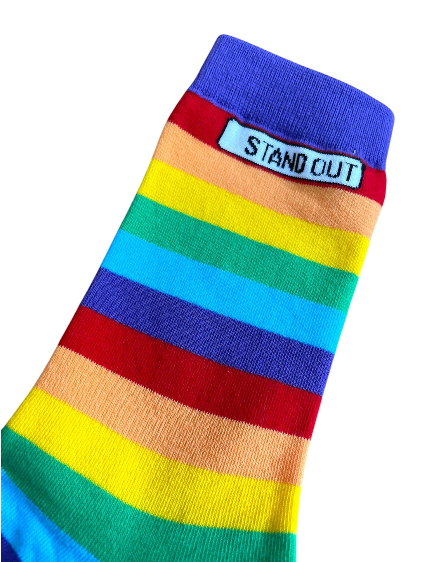 Close-up of the Stand Out Socks Rainbow Pride socks, featuring a colourful striped pattern and the Stand Out logo at the top