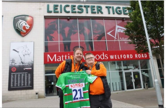CoFounders of Stand Out Socks, Stood Outside of Leicester Tigers Holding A Leicester Tigers Top branded with Stand Out 21