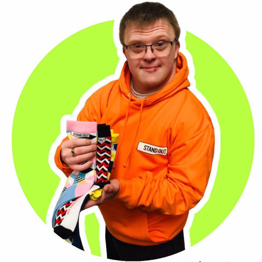 Ross from Stand Out Socks holding socks