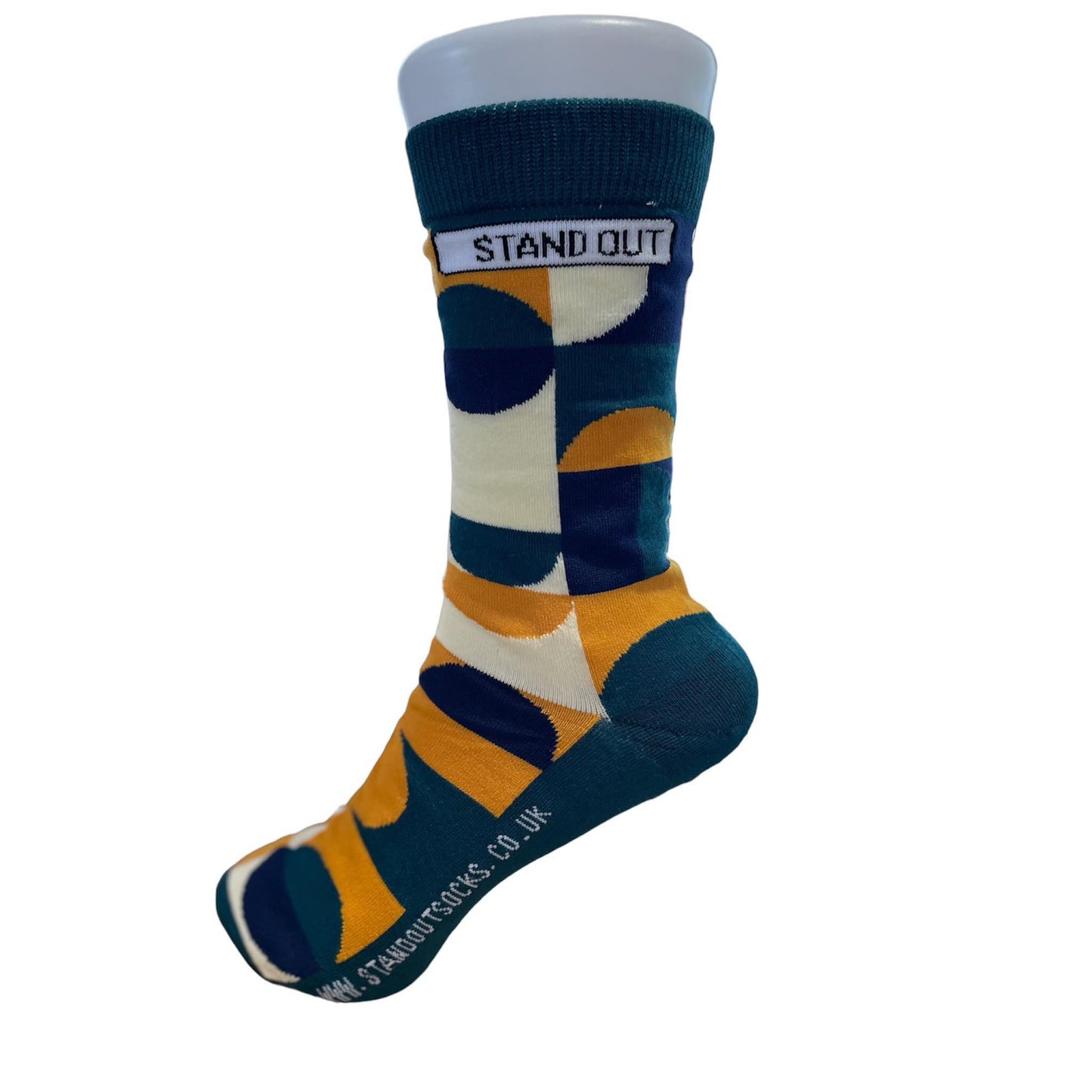 Green Socks with Orange, cream and navy geometric pattern by Stand Out Socks. The Stand Out logo on the top with the Stand Out website on the sole.