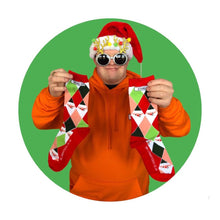 Load image into Gallery viewer, stand out socks co founder ross holding Christmas socks with Christmas hat and glasses on
