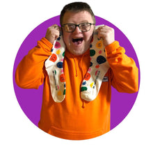 Load image into Gallery viewer, Man holding smiley face socks
