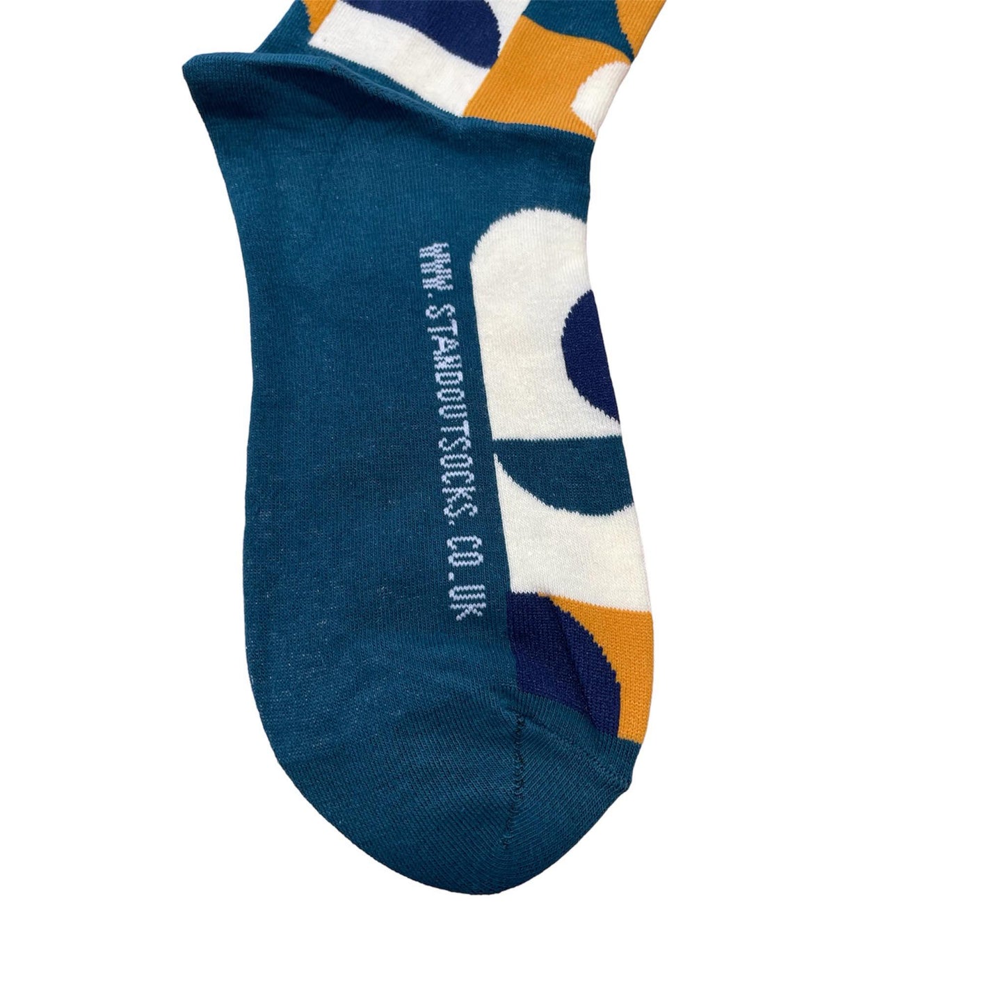 Green Socks with Orange, cream and navy geometric pattern by Stand Out Socks. The Stand Out logo on the top with the Stand Out website on the sole.