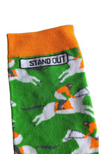 Load image into Gallery viewer, Vibrant photograph of a horse and jockey in action, featuring eye-catching orange and green socks, adding a touch of excitement and energy to the race
