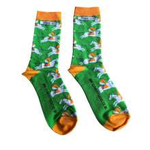 Load image into Gallery viewer, Vibrant photograph of a horse and jockey in action, featuring eye-catching orange and green socks, adding a touch of excitement and energy to the race
