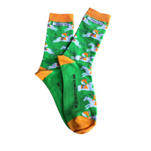 Load image into Gallery viewer, Vibrant photograph of a horse and jockey in action, featuring eye-catching orange and green socks, adding a touch of excitement and energy to the race
