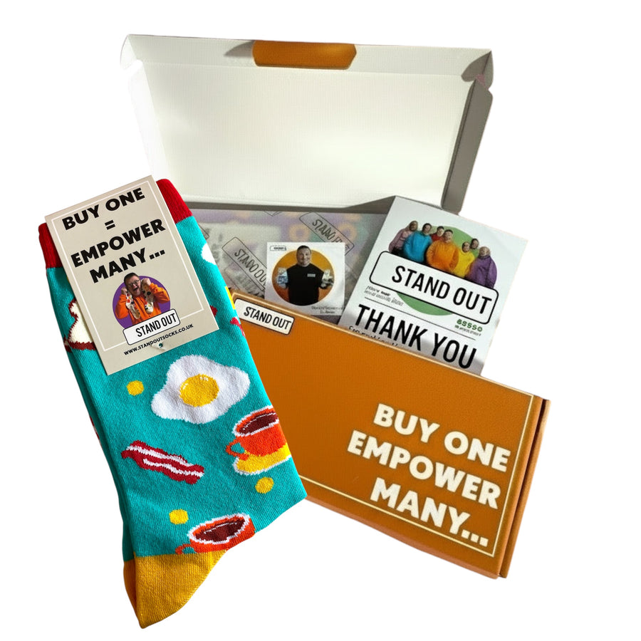 Colorful socks with a coffee cup design, branded cards, and a box on a white background.