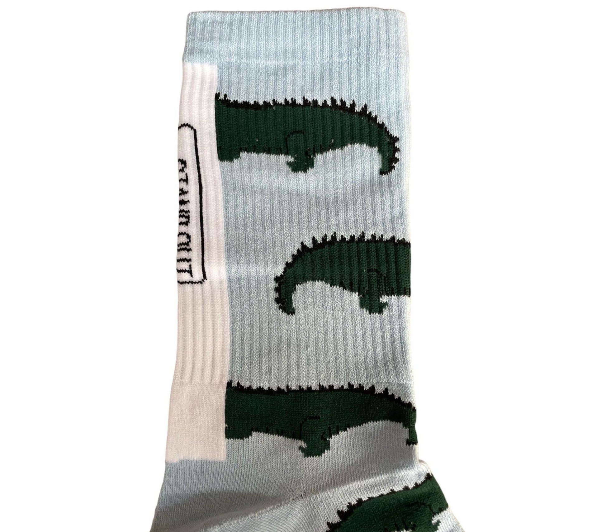 A Close up of a colourful Stand Out Sports Socks with a Blue and Green Crocodile Pattern.