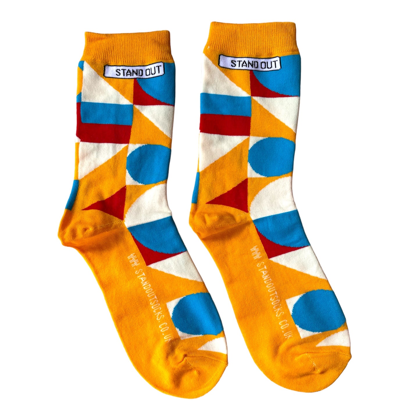 Orange socks with blue, cream and red geometric pattern by Stand Out Socks. The Stand Out logo on the top with the Stand Out website on the sole.