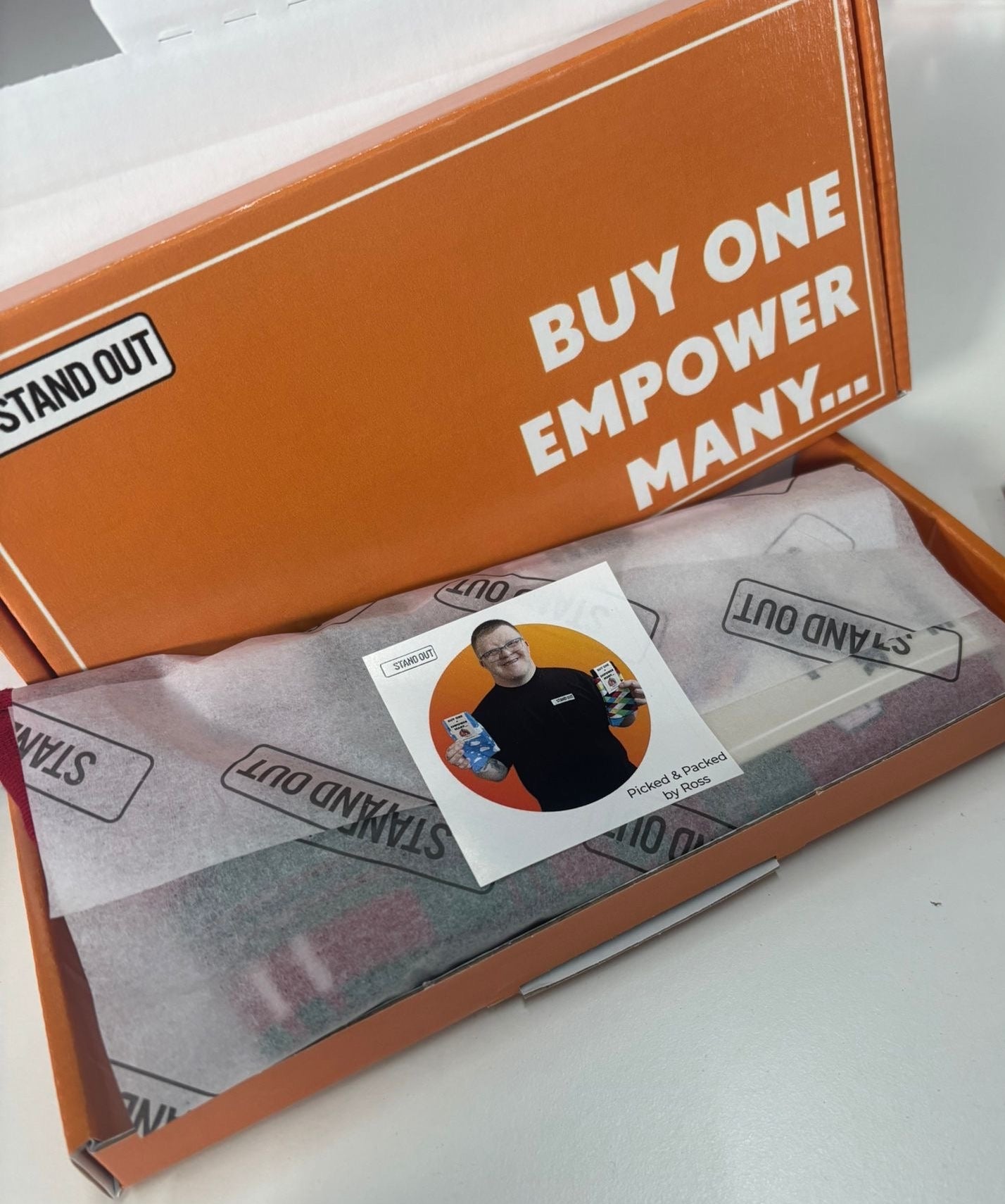 Open box with a product and promotional text on a white background