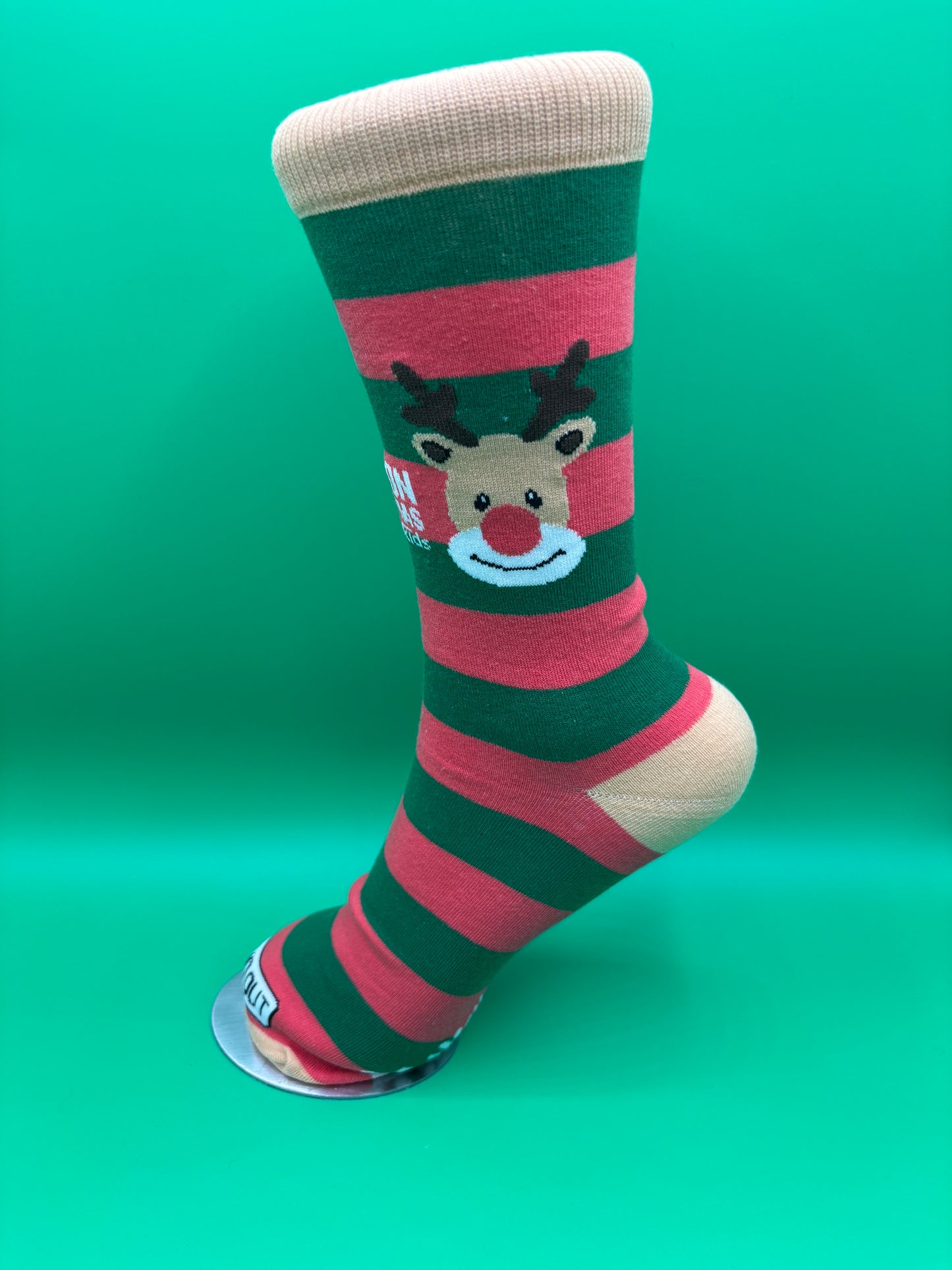 Striped sock with a reindeer design on a green background