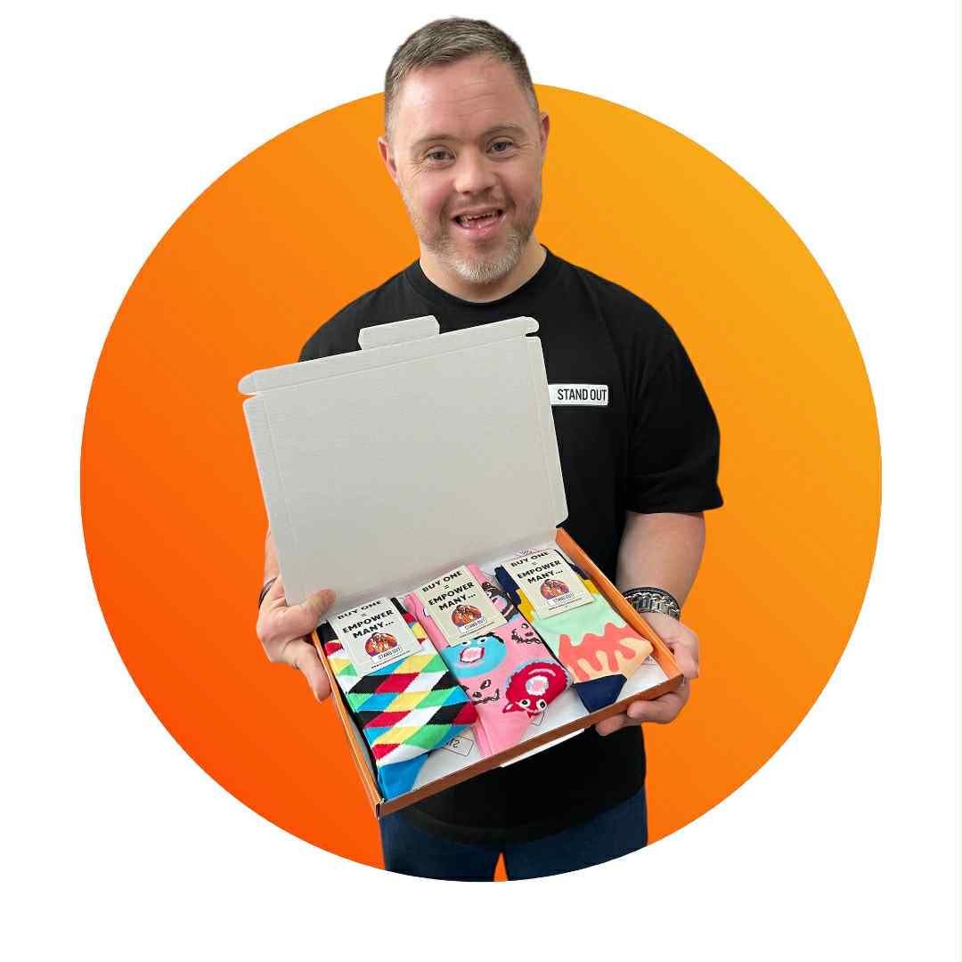 Man holding a box of colorful socks with an orange circle background