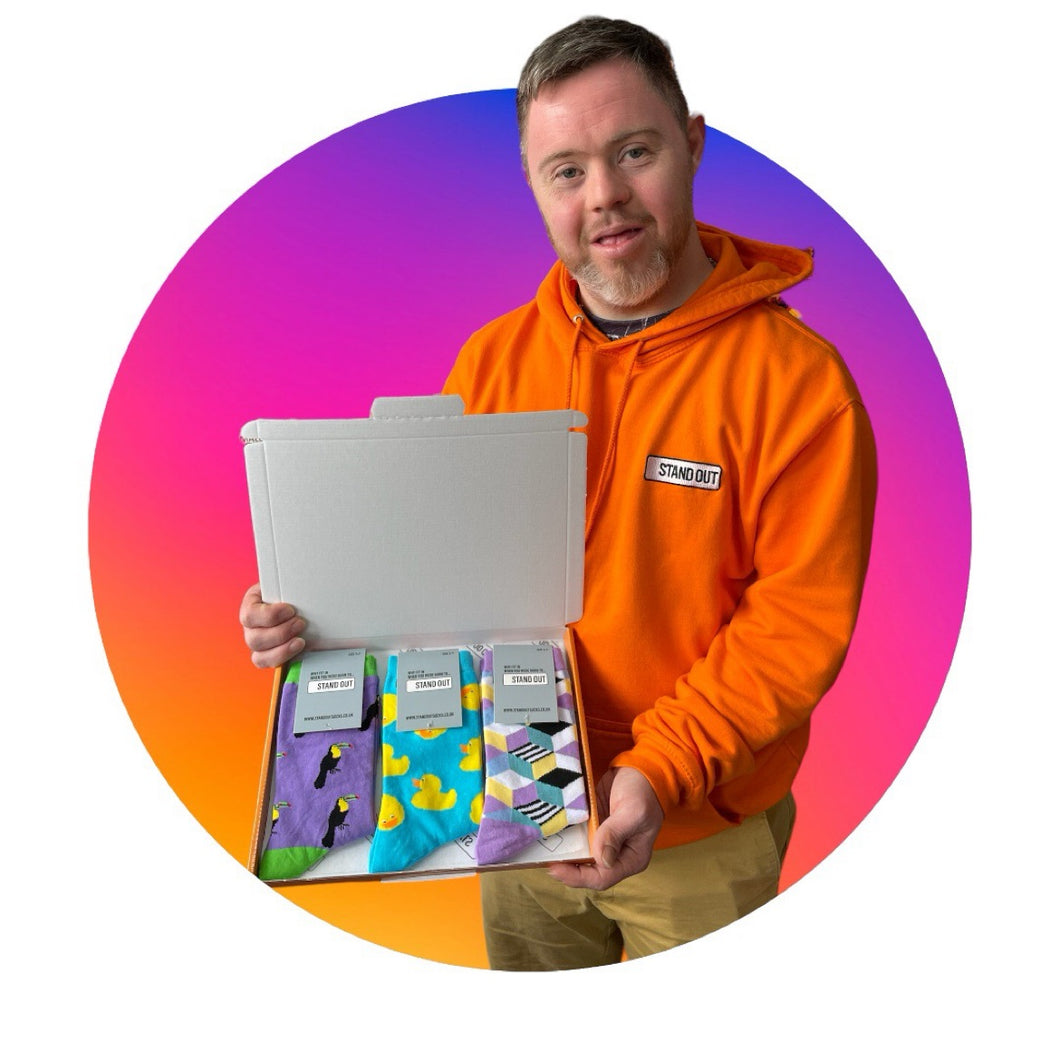 man holding a box with colourful socks inside